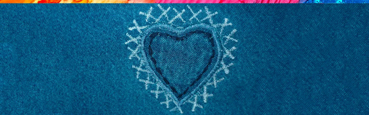 Dark blue fabric with an embroidered heart in the center.