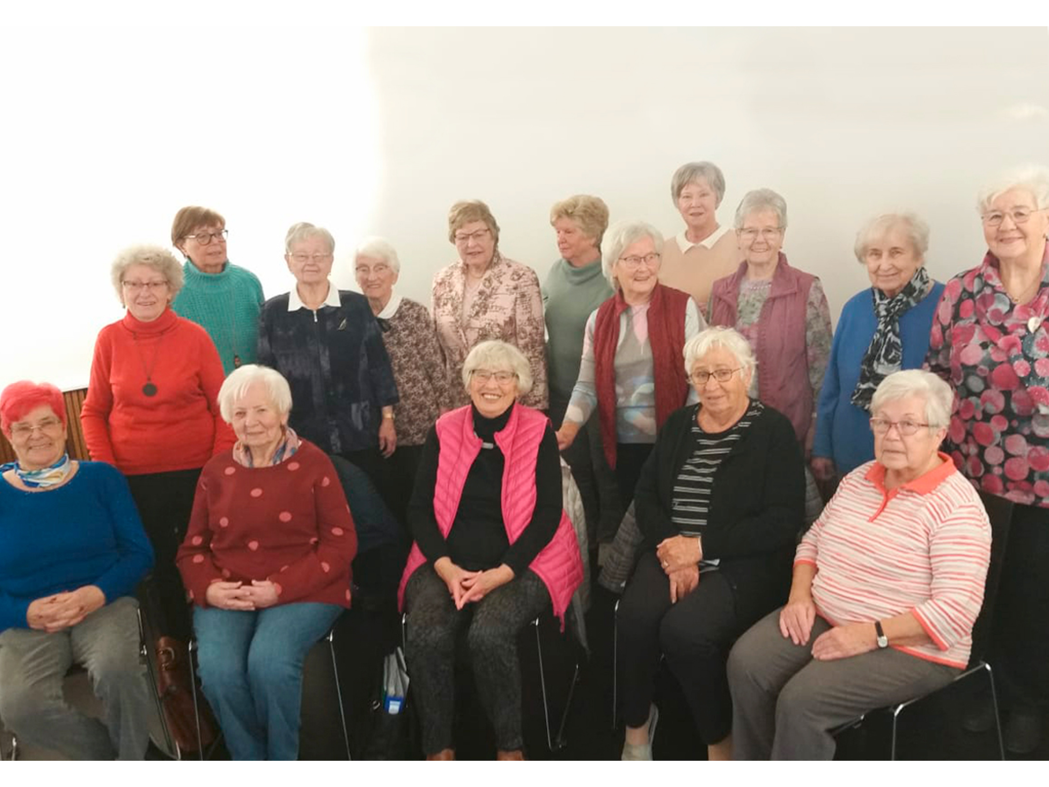 Gruppe älterer Frauen posiert für ein Foto.